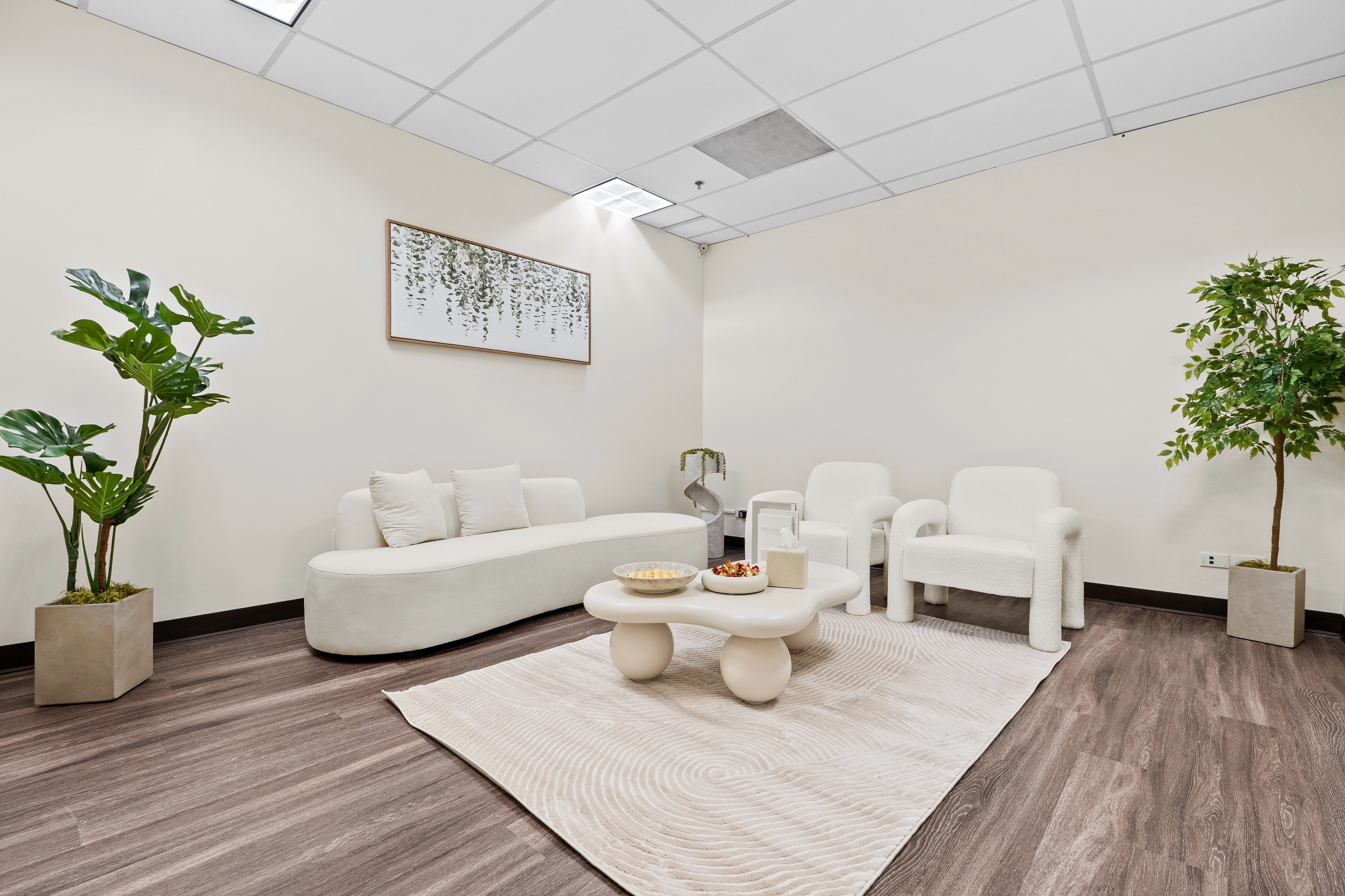 Elegant lounge with curved sofa and botanical art