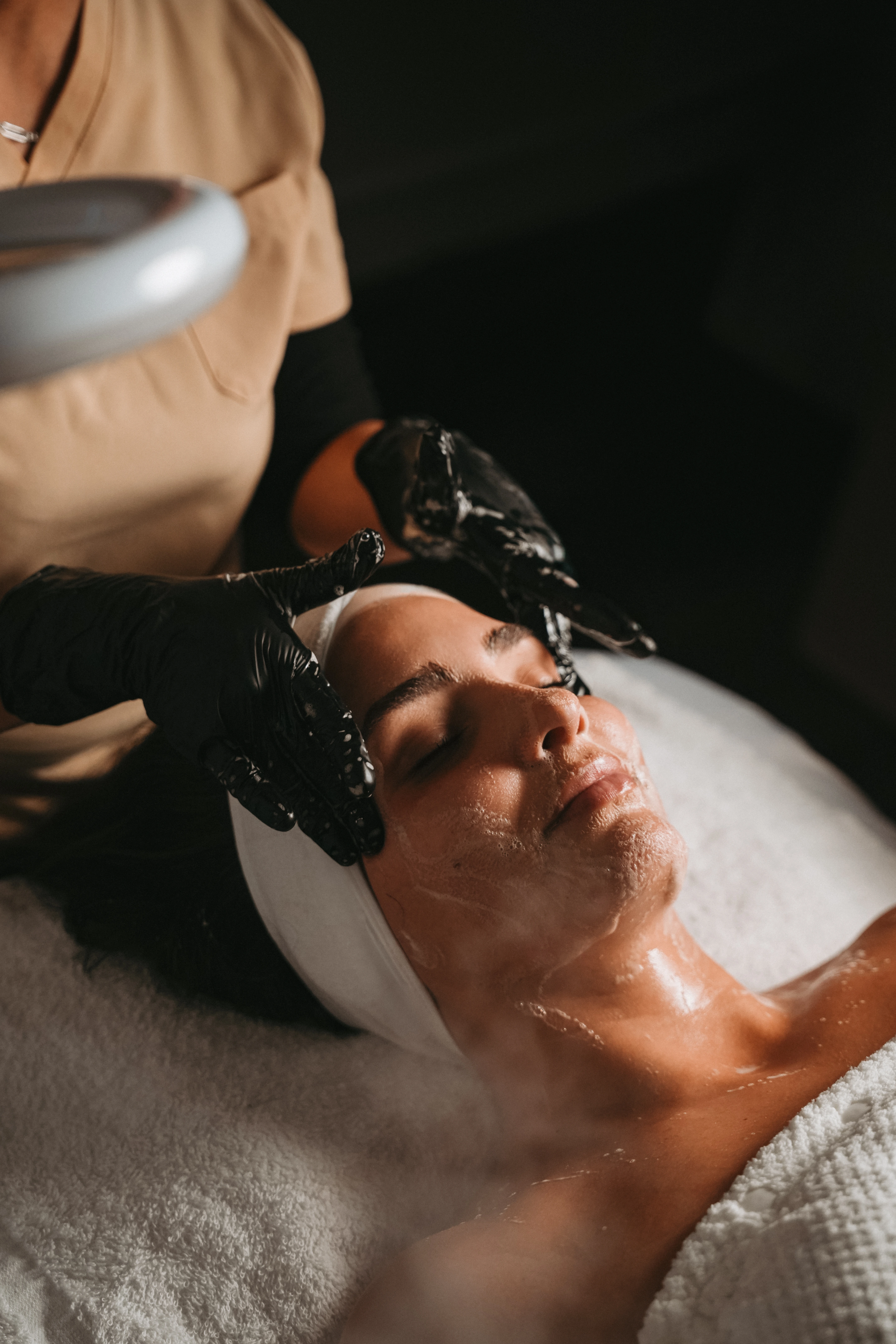Facial treatment with magnifying lamp